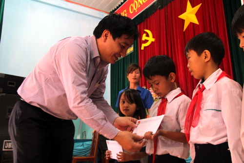 Đồng chí Nguyễn Đắc Vinh trao học bổng cho các em học sinh nghèo có thành tích học tập xuất sắc tại xã